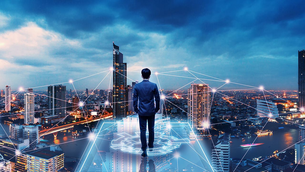 Business man on future network city | Image credit: © Peera - © Peera - stock.adobe.com 