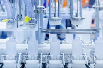 robot arm moving plastic bottle to conveyor belt of auto capping and labeling machine at cosmetic and skin care manufacturing. cosmetic industry and ai technology machinery concept. | Image Credit: © gumpapa - stock.adobe.com
