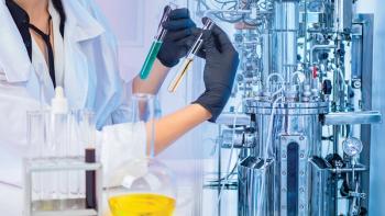 Liquid obtained in the fermentation process. Microbiologist with test tubes in his hands. Chemical laboratory equipment. Laboratory bioreactor for the production of vaccines. Pharmacology. | Image Credit: © Grispb –  © Grispb - stock.adobe.com