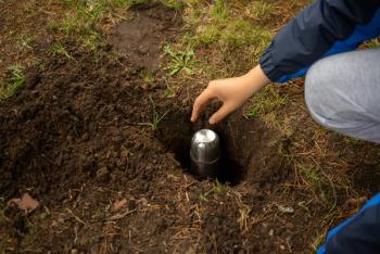 Bury the time capsule in the ground.A message for posterity in an iron bottle.Hide the jewels in the ground. Lower the bottle with the message into the pit. | Image Credit: © Svetliy - stock.adobe.com