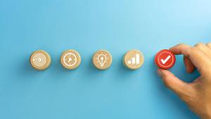 Business process management, Businessman plan a project with wooden cubes with icon business strategy on blue background. copy space. Image Credit: ©Worawut -Worawut - Stock.adobe.com