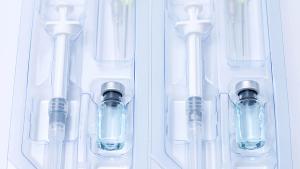 Covid-19, flu, coronavirus liquid vaccine vial bottle and syringe set in plastic package container preparing for injection on white background. Vaccination for fight Covid-19 virus concept. | Image Credit: ©Aonprom Photo -stock.adobe.com