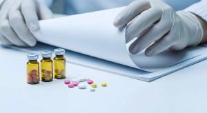 Scientist Examining Medical Documents Near Ampoules and Pills | Image Credit: ©PixelPulse-stock.adobe.com