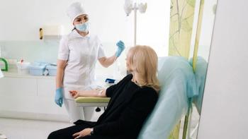 Sick woman sitting on chair talking to friendly nurse. Healthcare worker in mask taking care of female patient in hospital with IV drip. Medicine, vitamin therapy, medication concept | Image Credit: ©dikushin - Stock.adobe.com