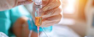 Cancer patient receiving infusion therapy in clinical trial setting for diffuse large B-cell lymphoma treatment. | Image Credit: © IYearDesign - stock.adobe.com
