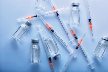 A lot of vials and syringes on blue table top view | Image Credit: Davizro Photography - stock.adobe.com