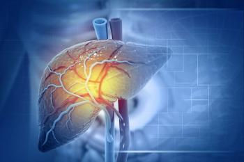 3D illustration of a human liver against a blue background, with branching blood vessels across its surface, two large vessels at the top, and a yellow glow at the center of the organ. | Image Credit: © Crystal lite - stock.adobe.com