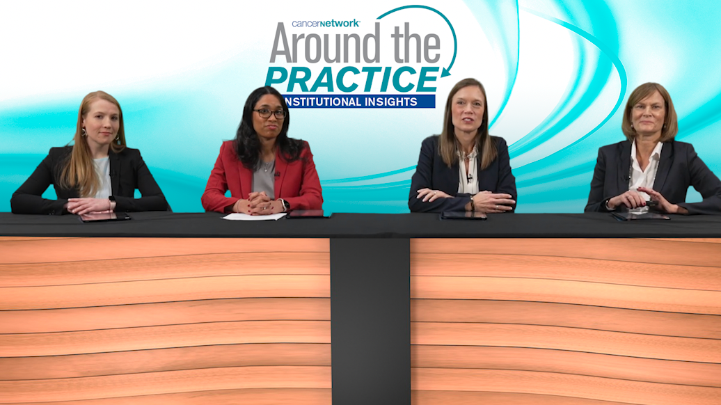A panel of 4 experts on breast cancer seated at a long table