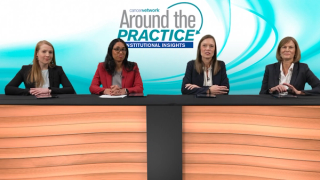 A panel of 4 experts on breast cancer seated at a long table