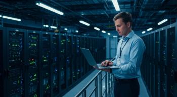 Man works on a laptop in a modern data center environment. Generated with AI. | Image Credit: © ekalaila - stock.adobe.com.
