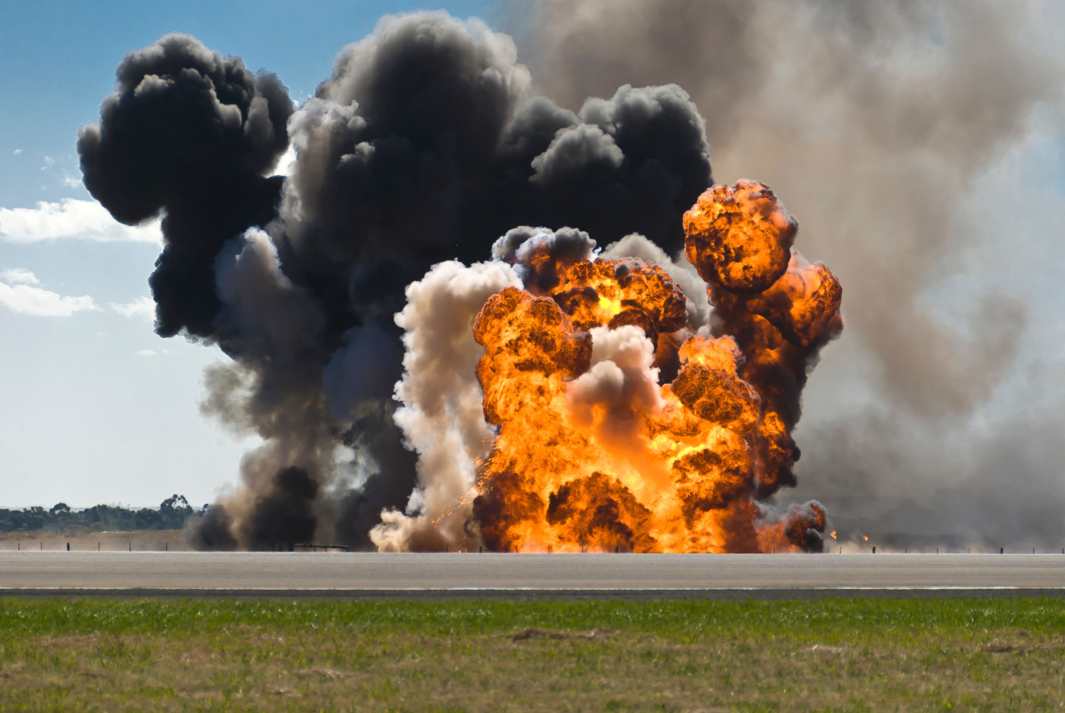 Fiery explosion with thick black smoke on an airport runway. | Image Credit: © andrewburgess - stock.adobe.com