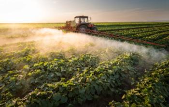 Farmer on a tractor with a sprayer makes fertilizer for young vegetable | Image Credit: © Dusan Kostic - stock.adobe.com