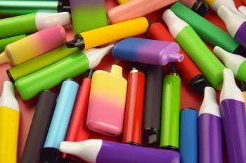 Set of multicolor disposable electronic cigarettes on a red background. | Image Credit: © iama_sing - stock.adobe.com