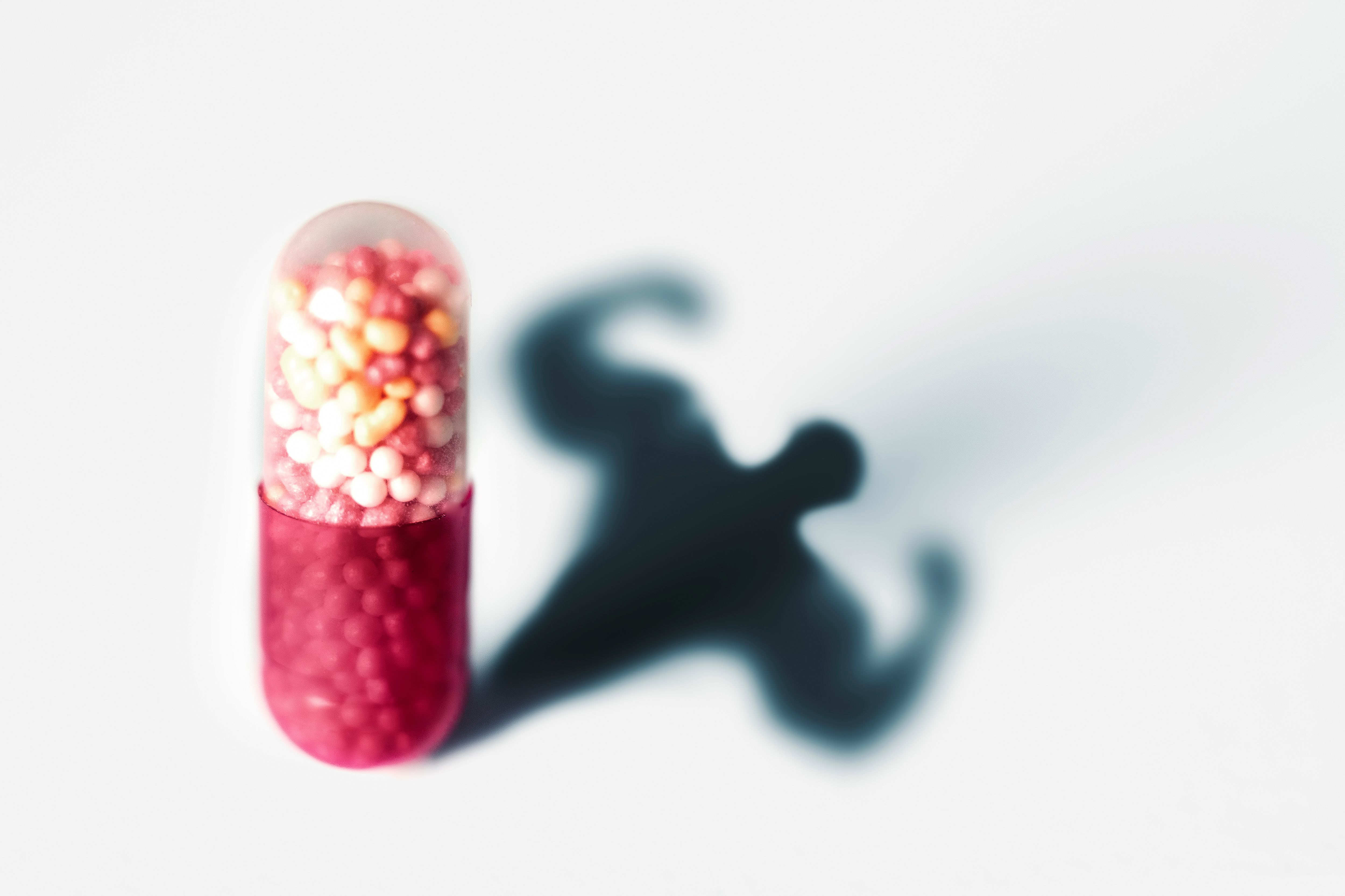Sports doping, anabolic capsule - shape of a male muscular upper body - symbol for medical drug abuse. | Image Credit: © Andy Shell - stock.adobe.com