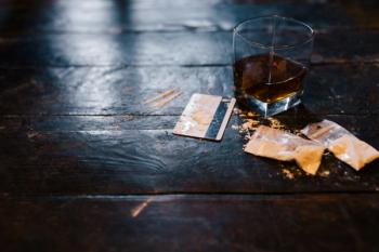Cocaine and alcohol drink on dark background. Detrimental lifestyle. Bad habits. Alcohol and drug addiction. Important problem of modern society | Image Credit: © igor_kell - stock.adobe.com