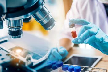 lab technician assistant analyzing a blood sample in test tube at laboratory with microscope. Medical, pharmaceutical and scientific research and development concept. | Image Credit: © totojang1977 - stock.adobe.com