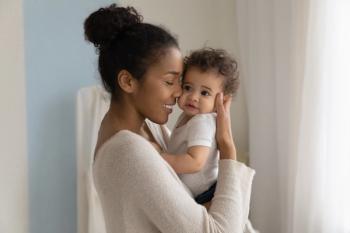 Happy young African American mom hold in hands hug cute little ethnic baby toddler show love care. Smiling biracial mother embrace cuddle small newborn infant child. Motherhood, childcare concept. | Image Credit: © fizkes - stock.adobe.com