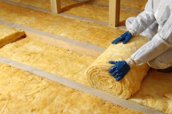 Worker insulate the attic with mineral wool | Image Credit: © Alekss - stock.adobe.com