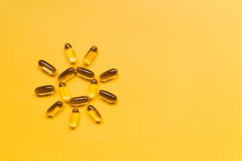 Close up capsules of fish fat oil in the sun shape, omega 3, vitamin e on the yellow background. Healthy food diet. Nutritional supplement | Image Credit: © MagicalKrew - stock.adobe.com
