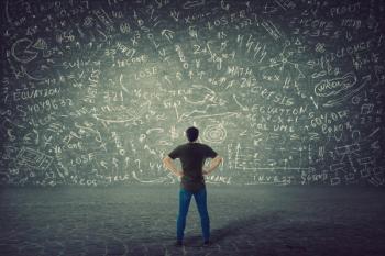 Rear view of puzzled student, hands on hips, stands in front of a huge blackboard try to solve hard mathematics calculation, formula and equations. Project ideas thinking