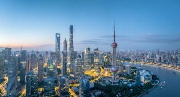 Panoramic view of a modern city skyline with iconic tower and illuminated buildings at twilight in Shanghai | Image Credit: © zhao dongfang - stock.adobe.com