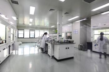 laboratory equipment with two scientists working at their respective desks.