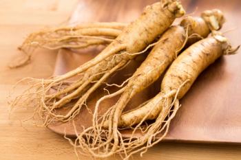 Fresh Korean Ginseng over wooden plate | Image Credit: © leungchopan - stock.adobe.com