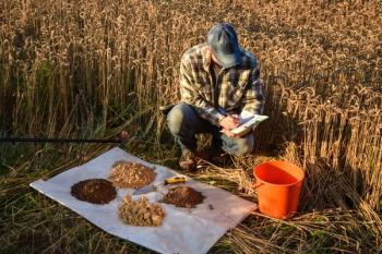 Male agronomist preparing soil samples for laboratory analysis, writing in information sheet outdoors at sunrise. Man farmer taking notes in form, working at field. Soil certification See Less | Image Credit: © AlDa.videophoto - stock.adobe.com