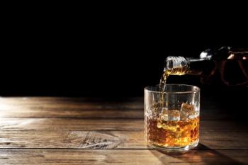 Pouring whisky into glass on wooden table closeup | Image Credit: © Africa Studio - stock.adobe.com