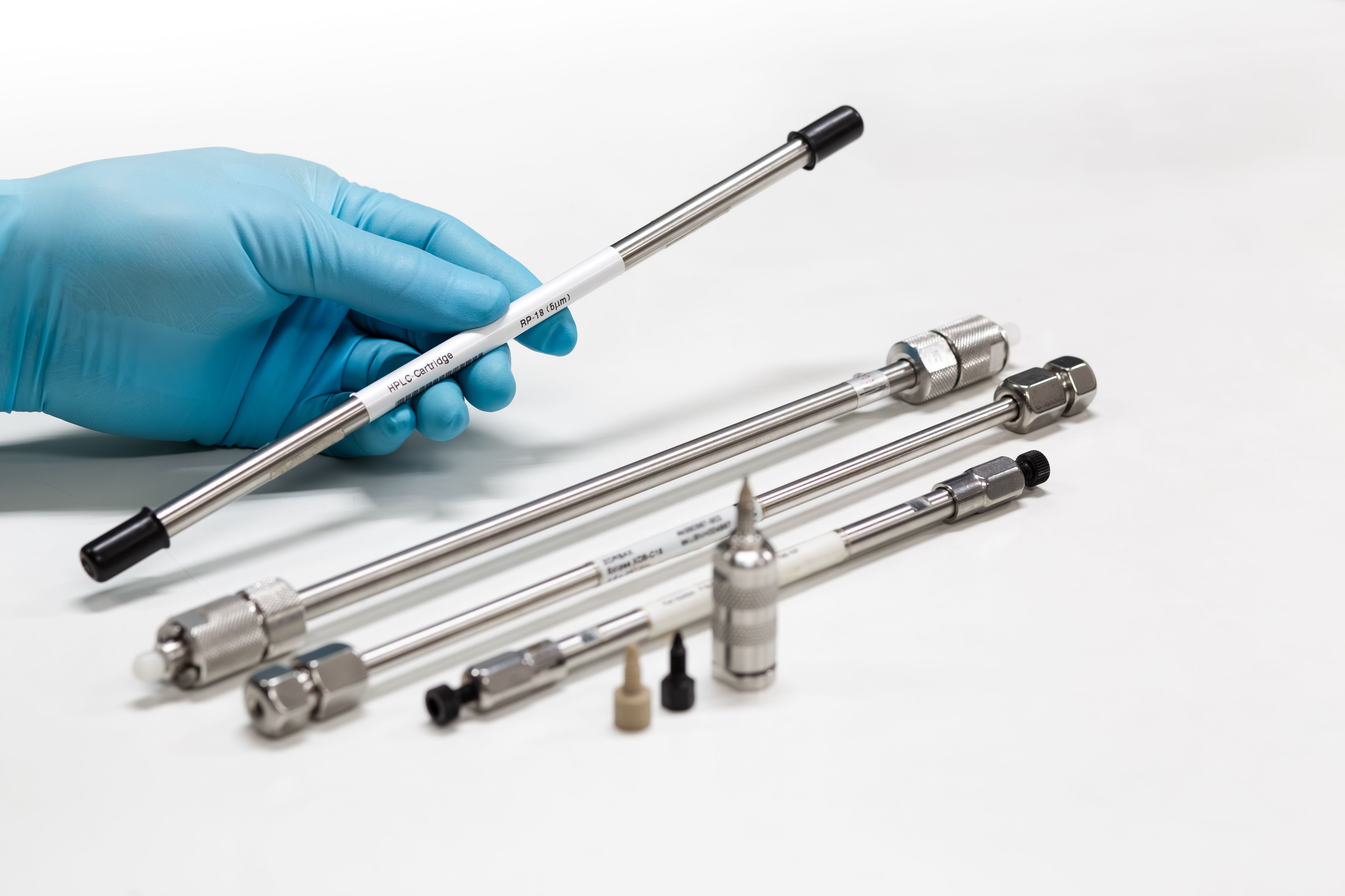 The researcher's hand shows the Cartridge column chromatography of the HPLC instrument. In addition, Cartridge column chromatography with guard cartridge column of HPLC, LC and LC-MS instruments. | Image Credit: © S. Singha - stock.adobe.com