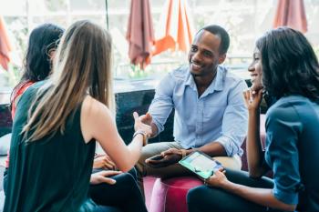 Business meeting in lobby of colorful modern office space | Image Credit: © Inti St. Clair - stock.adobe.com