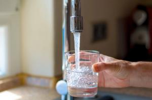 Woman filling a glass of water from a tap | Image Credit: © michaelheim