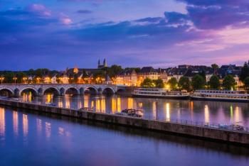 Maastricht Netherlands with 13th Century Sint Servaas bridge and Maas River around sunset | Image Credit: © allard1 - stock.adobe.com