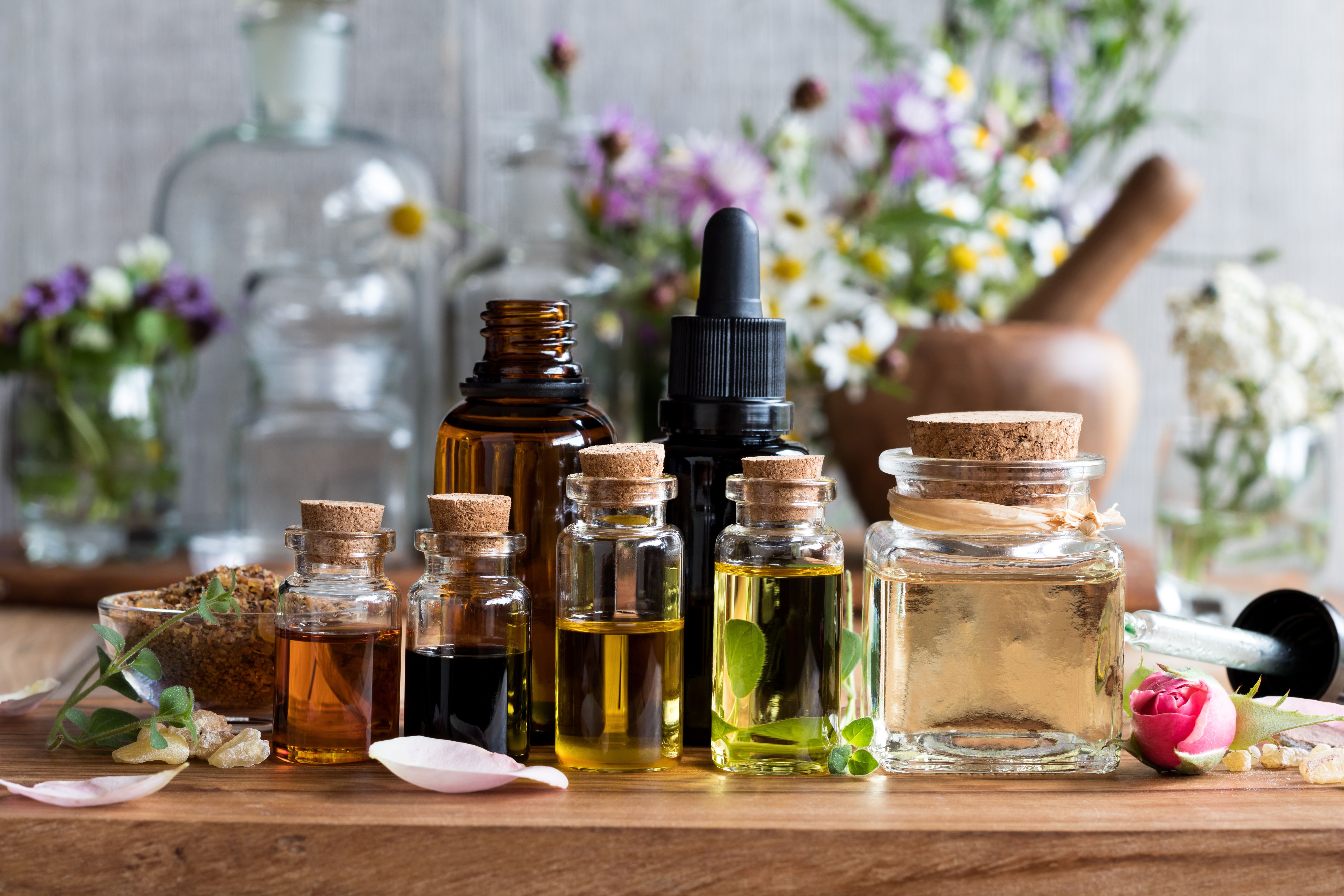 Selection of essential oils with herbs and flowers | Image Credit: © Madeleine Steinbach - stock.adobe.com