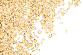 Lot of whole flat raw rolled oats left upper corner isolated on white background | Image Credit: ©PIXbank - stock.adobe.com