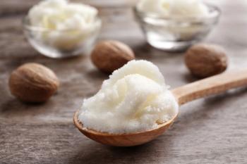 Shea butter in spoon and bowls on wooden background, close up | Image Credit: © Africa Studio - stock.adobe.com