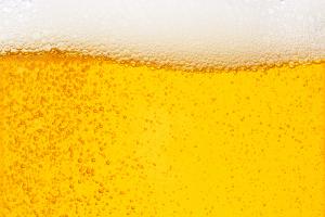 Pouring beer with bubble froth in glass for background on front view wave curve shape | Image Credit: © Love the wind - stock.adobe.com