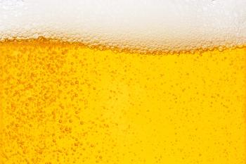 Pouring beer with bubble froth in glass for background on front view wave curve shape | Image Credit: © Love the wind - stock.adobe.com