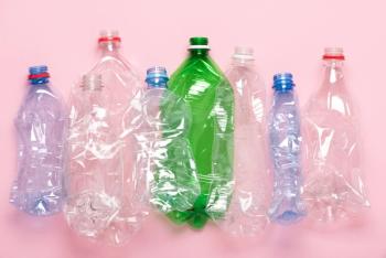 Plastic bottles on pink pastel background top view. Eco plastic recycling concept. | Image Credit: © nevodka.com - stock.adobe.com