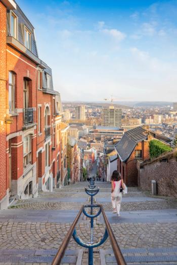 Scenic view of a female walking down the Montagne de Bueren stairway in Liege, Belgium | Image Credit: © Bart Ros/Wirestock Creators - stock.adobe.com
