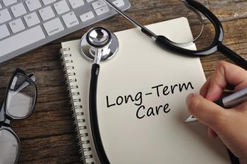 Women Hand Write "long-term care" On Note Book