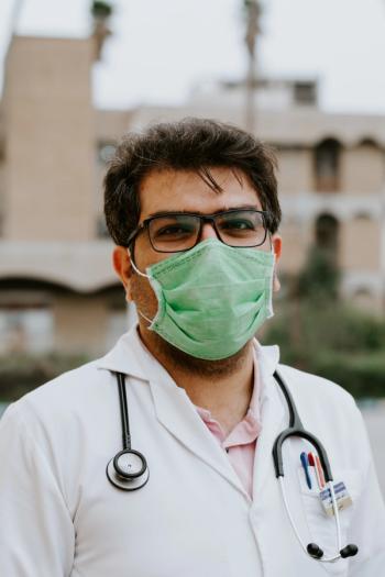doctor in white scrubs fighting COVID-19 face mask