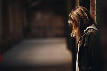 sad woman looking out a window