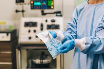 doctor opening surgical tools forceps