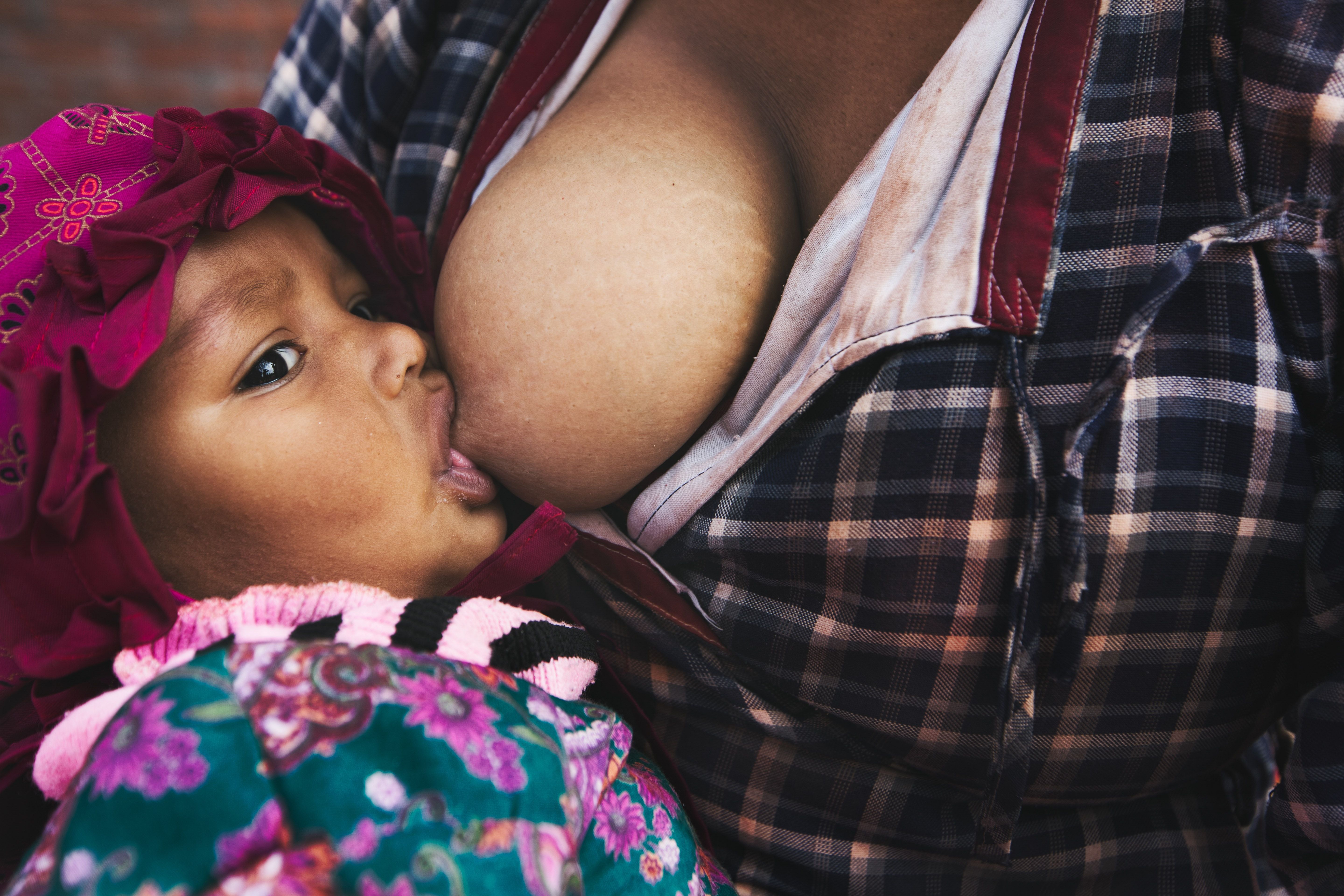 woman breastfeeding child