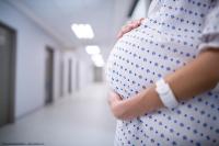 Mid section of pregnant woman standing in corridor | Image Credit: © WavebreakMediaMicro - stock.adobe.com