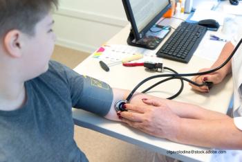 child having blood pressure taking