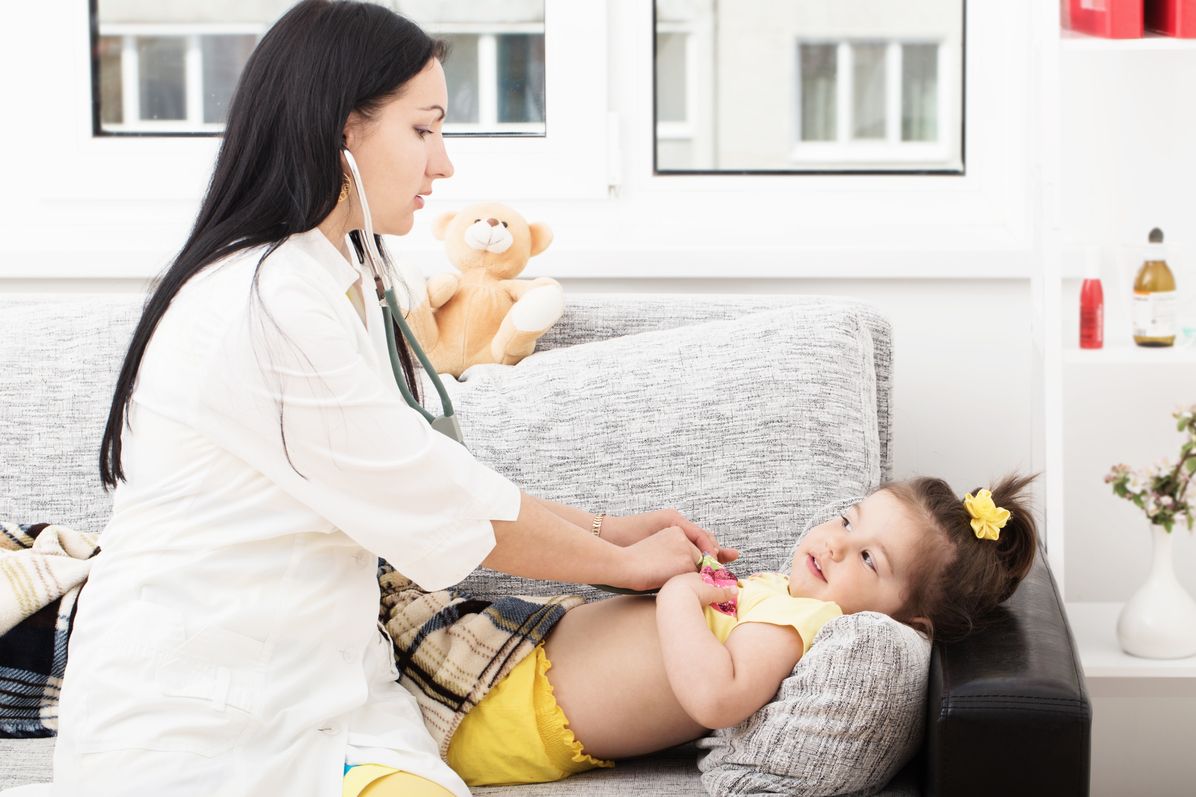doctor checking on patient with stethoscope