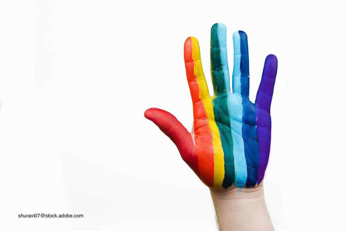 child with a hand painted like the pride flag