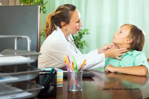 image of doctor examining teen patient's thyroid